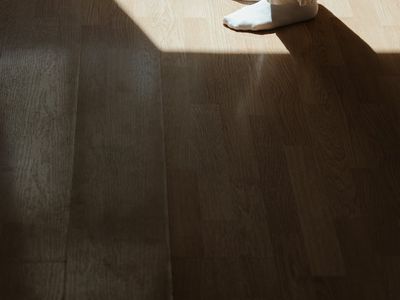 A wooden floor texture with soft morning shadows.