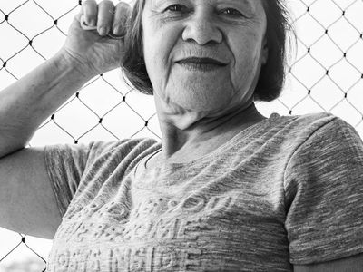 Shadows of a person moving gracefully against a white wall.